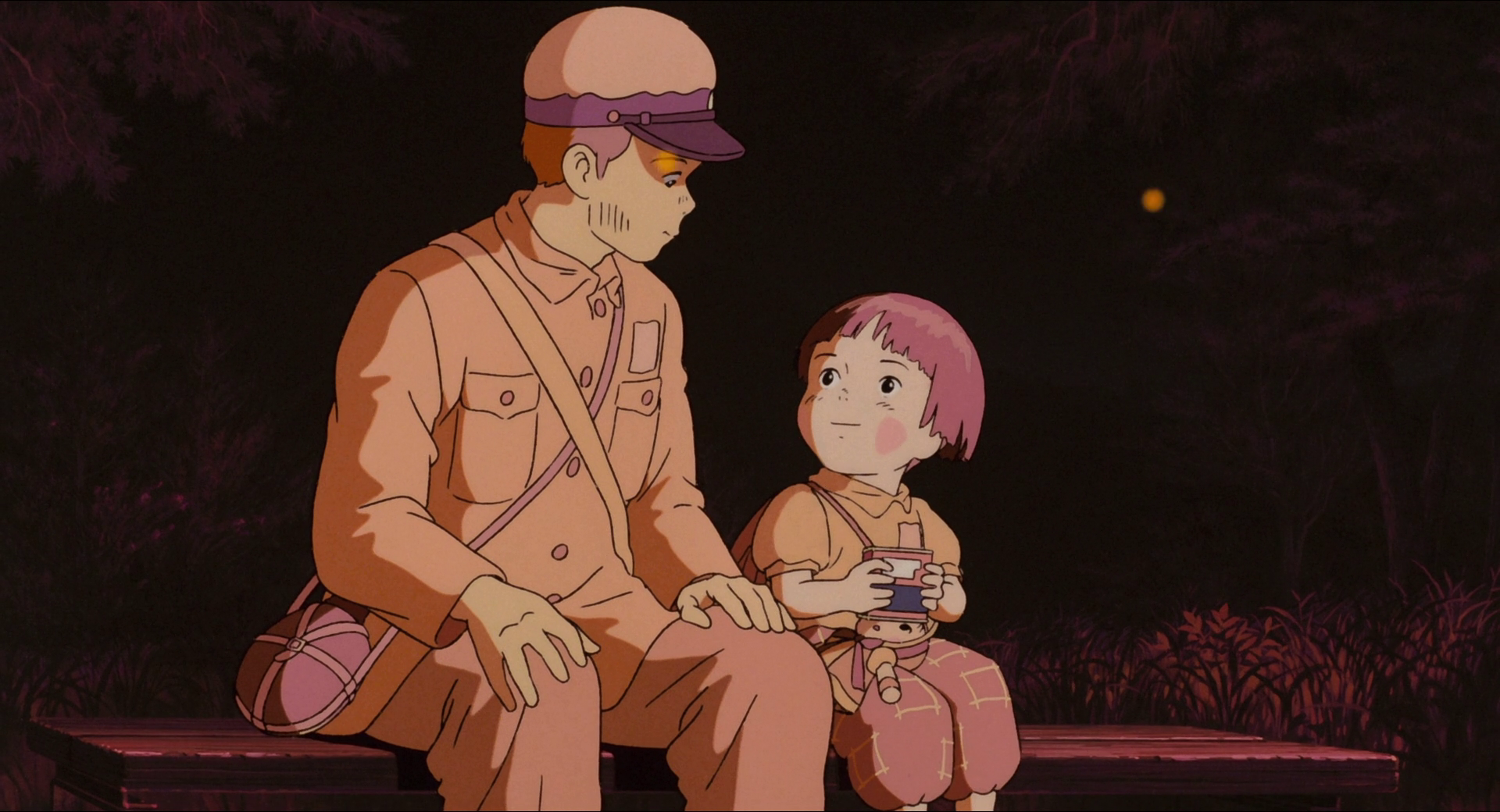 A young girl looks up at her older brother while holding a tin of candy. Both look a bit dirty and worn out.